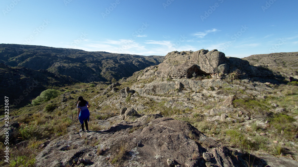 A hiker at Cerro Blanco reserve, near Tanti and Los Gigantes in the Altas Cumbres region, Cordoba, Argentina.