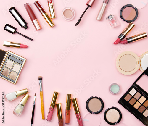 Banner of woman's cosmetics on pink background. Women's secrets. Decorative cosmetics: highlighter, concealer, rouge, palette with eye shadows and brushes for face make up, face sculpture. Copy space