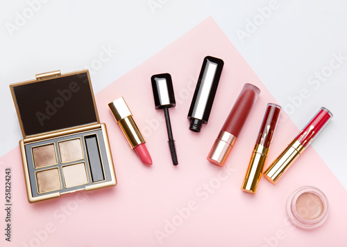 Set of woman s cosmetics on pink background. Women s secrets. Decorative cosmetics  highlighter  concealer  rouge  palette with eye shadows and brushes for face make up  face sculpture . Make up.