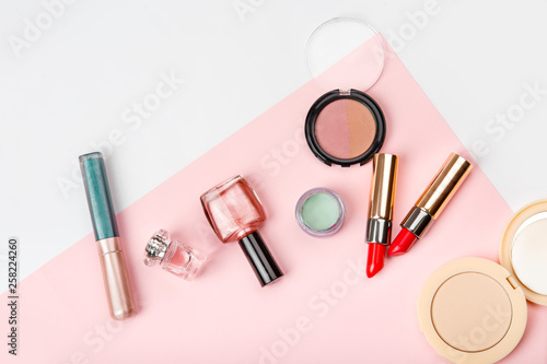 Set of woman's cosmetics on pink background. Women's secrets. Decorative cosmetics: highlighter, concealer, rouge, palette with eye shadows and brushes for face make up, face sculpture . Make up.