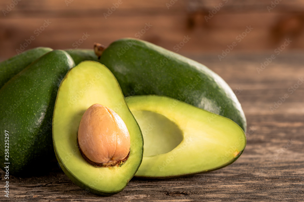 Heap of avocados on wooden table