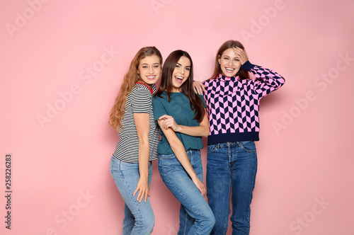 Portrait of young women laughing on color background. Space for text