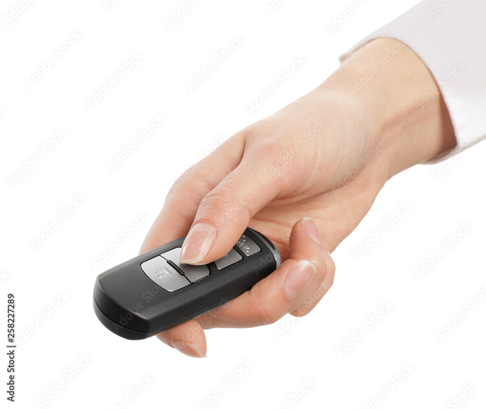Woman holding car smart key isolated on white Woman holding car smart key isolated on white
