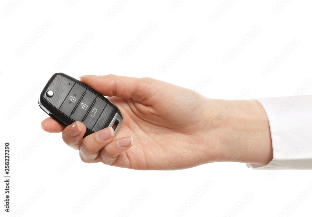 Woman holding car flip key isolated on white Woman holding car flip key isolated on white