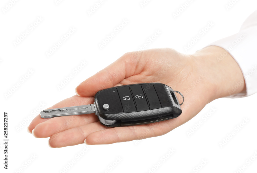 Woman holding car key isolated on white Woman holding car key isolated on white