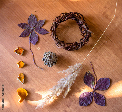 Dried flowers laid out on a wooden table, dried plants, Mendarine rind, Limmonica vine
