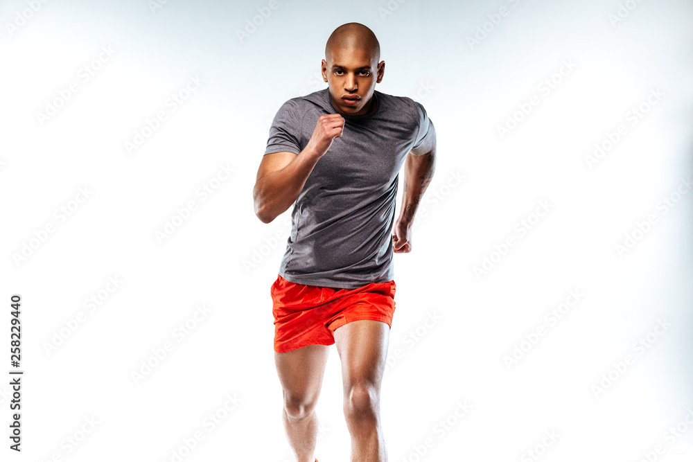 Sportsman wearing red suit doing running movements Sportsman wearing red suit doing running movements