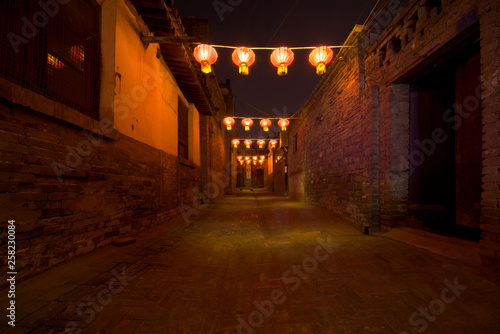 Red lanterns and bokeh at night in a street in Pingyao. The ancient city of Pingyao is a famous tourism destination. Shanxi, China photo