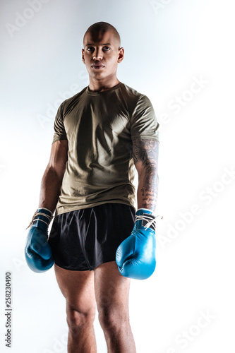 Strong young man wearing new boxing equipment © zinkevych