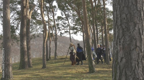 Fantasy Group walking on hill between trees photo