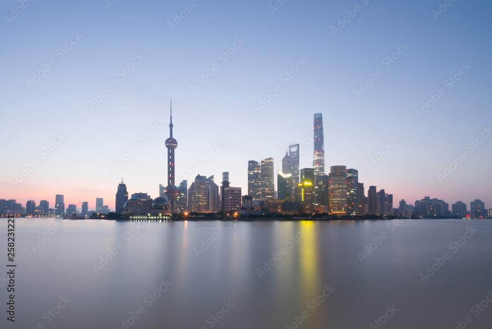 Long exposure of Pudong district, modern skyscrapers and Huangpu river in Shanghai at sunrise. Urban architecture in China