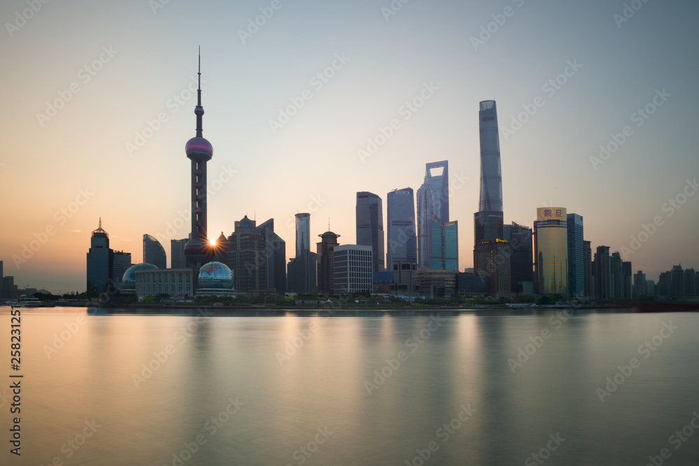 The Bund early in the morning at sunrise. View of Pudong and Huangpu river from The Bund in Shanghai, China The Bund early in the morning at sunrise. View of Pudong and Huangpu river from The Bund in Shanghai, China