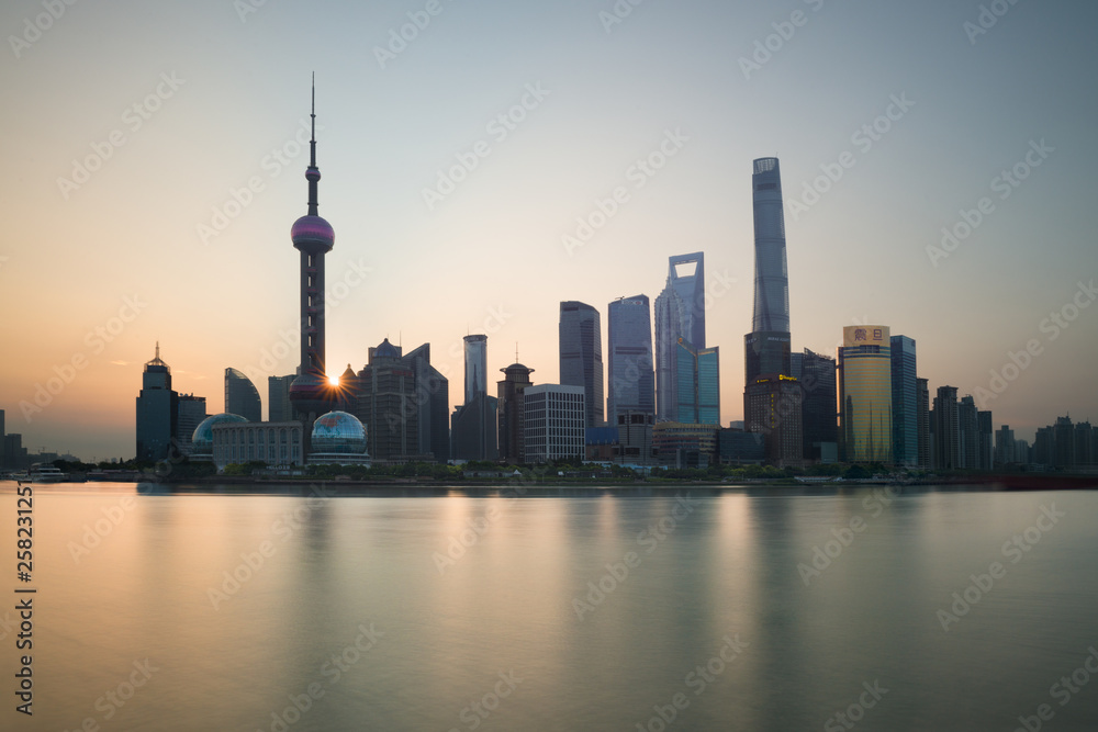 The Bund early in the morning at sunrise. View of Pudong and Huangpu river from The Bund in Shanghai, China