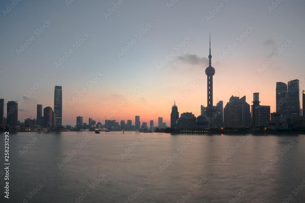 The Bund early in the morning at sunrise. View of Pudong and Huangpu river from The Bund in Shanghai, China