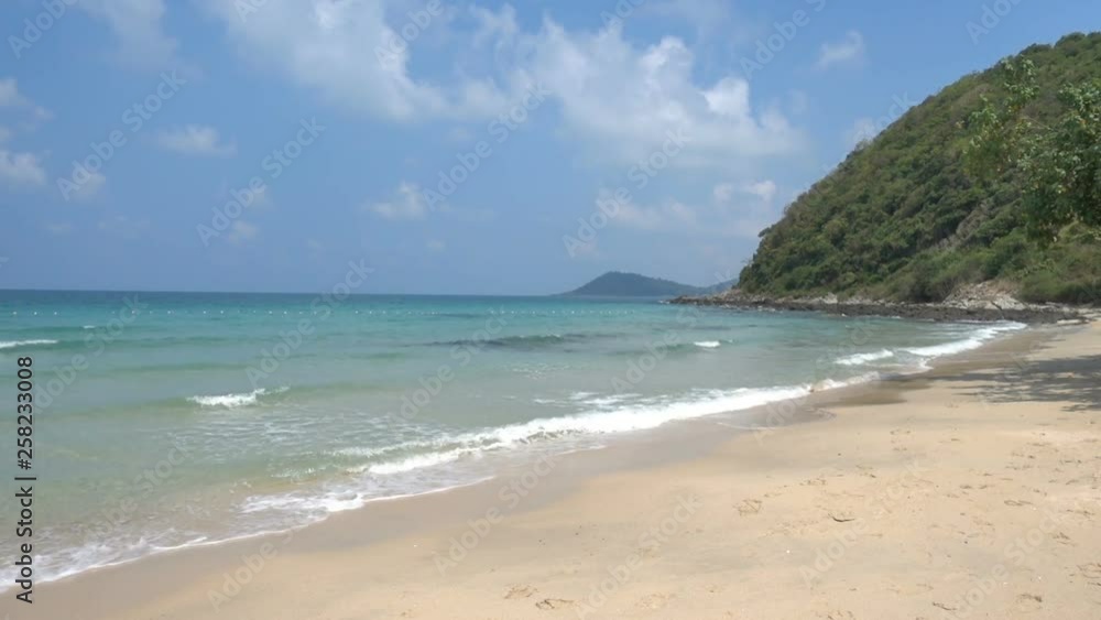 A hill at the beach with waves of the ocean. A hill at the beach with waves of the ocean.