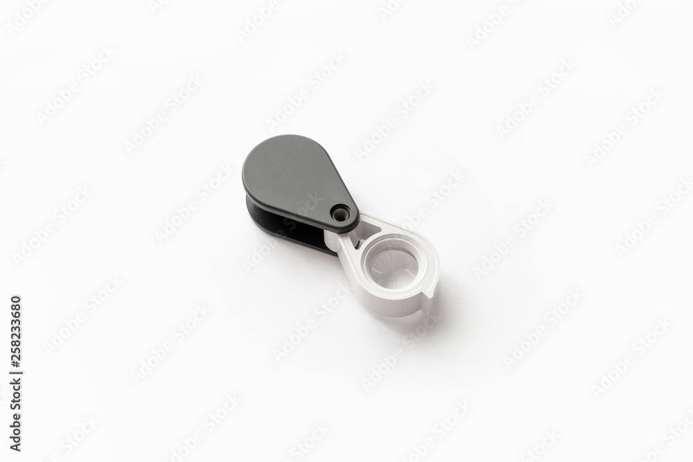 Magnifying glass for diamonds or see the amulet Isolated on a White Background. Magnifying glass for diamonds or see the amulet Isolated on a White Background.
