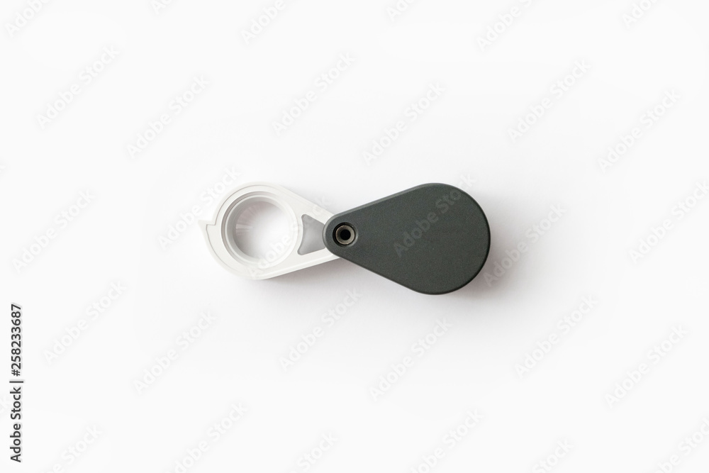 Magnifying glass for diamonds or see the amulet Isolated on a White Background. Magnifying glass for diamonds or see the amulet Isolated on a White Background.
