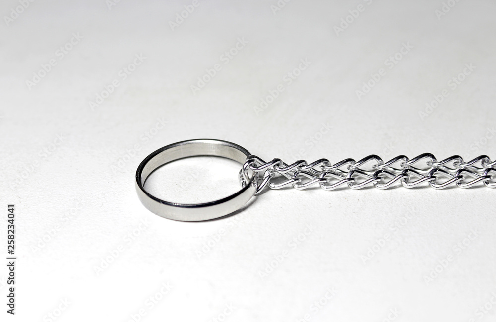 Silver ring tied in chain. On white background Silver ring tied in chain. On white background