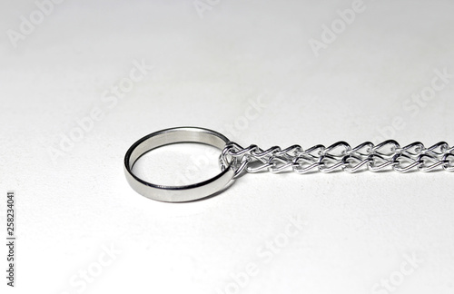 Silver ring tied in chain. On white background