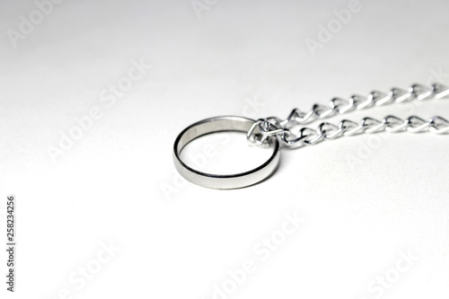 Silver ring tied in chain. On white background