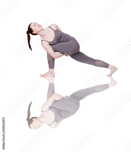 young girl performs different poses of yoga, flexible beautiful model on a white background. meditation and asanas.