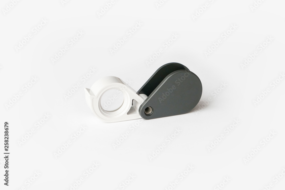 Magnifying glass for diamonds or see the amulet Isolated on a White Background. Magnifying glass for diamonds or see the amulet Isolated on a White Background.