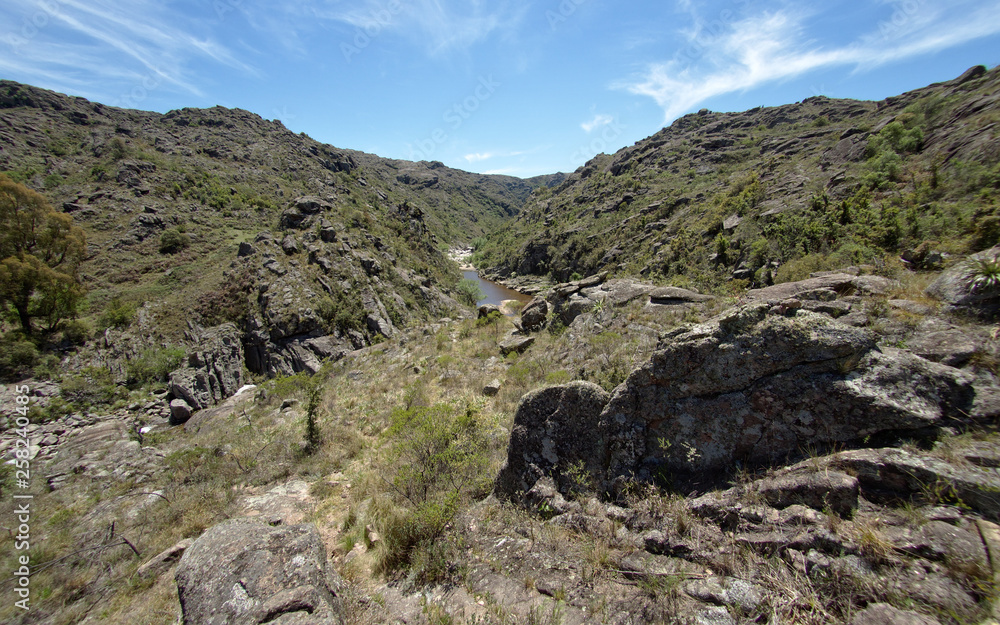 View of the Yuspe river running through the mountains at Cerro Blanco reserve, near Tanti and Los Gigantes, Cordoba, Argentina