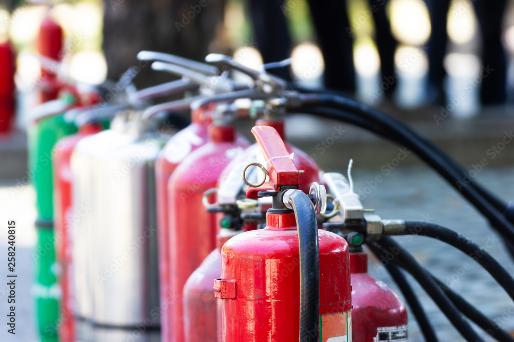 Close up Fire Safety Set Different Types of Extinguishers Placed outdoors for staff training.