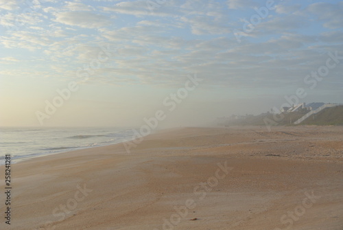 Foggy beach at sunrise