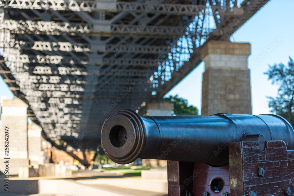 Historic cannon under Sydney Harbour Bridge. Military defence concept Historic cannon under Sydney Harbour Bridge. Military defence concept
