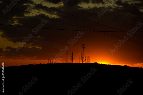 Telephone antennas contrast with the beautiful sunset of the Brazilian backwoods. Photo taken in the city of Vitória da Conquista.