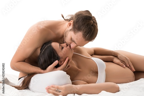 Happy family kissing in bed isolated shot