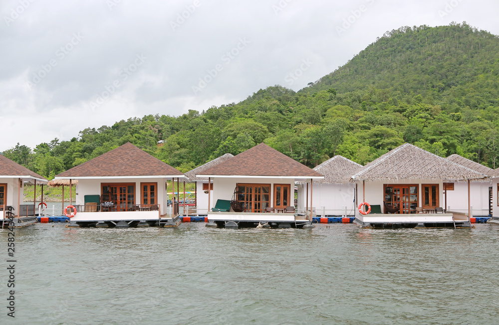 Naklejka premium Raft House floating on the river with mountain at kanchanaburi, Resort in thailand.