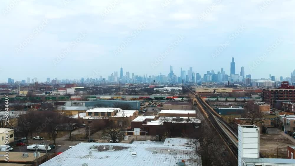 Chicago Illinois/United States March 28th 2019: drone footage of an urban community near downtown Chicago over by the CTA Train stop. a complete view of the Chicago skyline on an overcast day Chicago Illinois/United States March 28th 2019: drone footage of an urban community near downtown Chicago over by the CTA Train stop. a complete view of the Chicago skyline on an overcast day