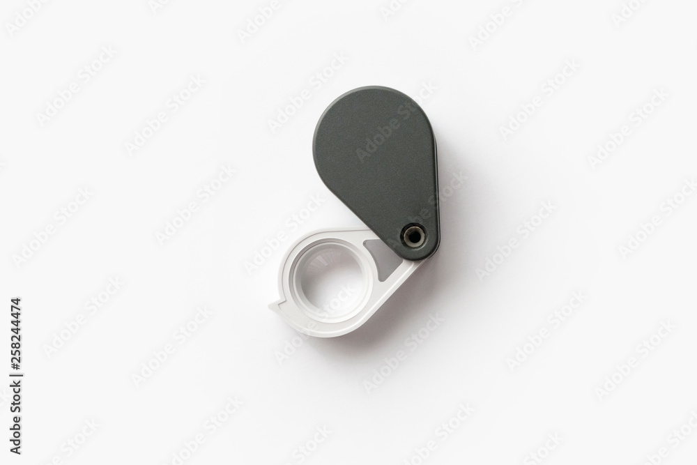 Magnifying glass for diamonds or see the amulet Isolated on a White Background. Magnifying glass for diamonds or see the amulet Isolated on a White Background.