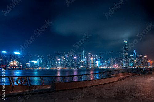 Photography Hong Kong cityscape at night. Tourists walking on the waterfront