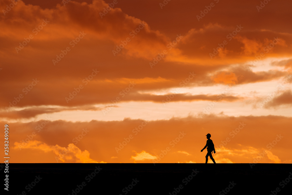 Silhouette of a technician on sunset background