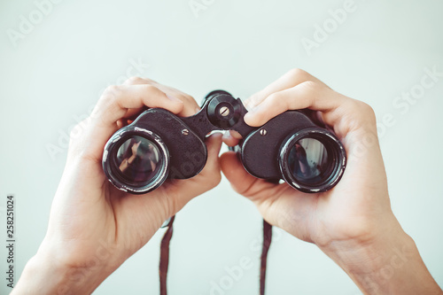 man holding binoculars photo