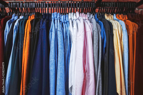 Multi colored clothing hanging on hangers