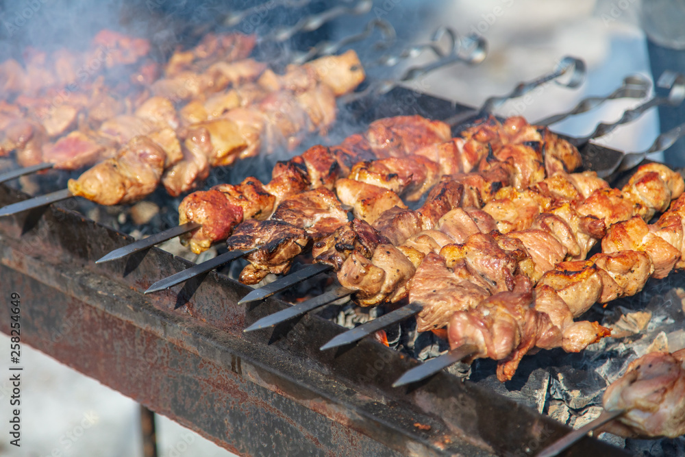 Shish kebab on sticks fried on coals in nature Shish kebab on sticks fried on coals in nature
