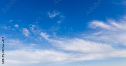 Clouds against the blue sky as a background