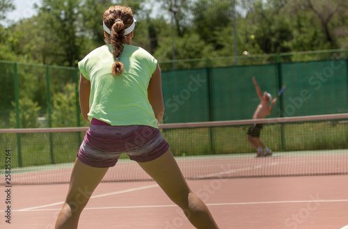 Girl playing tennis on the court © schankz