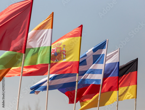 Flags of countries against a blue sky