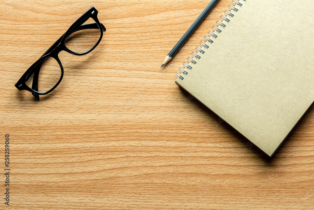 book, pencil and a glasses on wooden desk. - for creative and business concept background. book, pencil and a glasses on wooden desk. - for creative and business concept background.