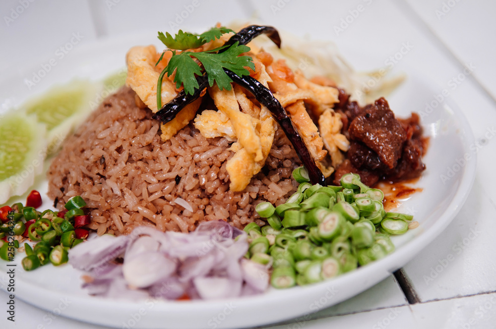 Thai shrimp paste fried rice with shallot, sweet barbeque pork, egg and vegetable Thai shrimp paste fried rice with shallot, sweet barbeque pork, egg and vegetable