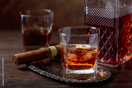 Whiskey with ice and cigar.