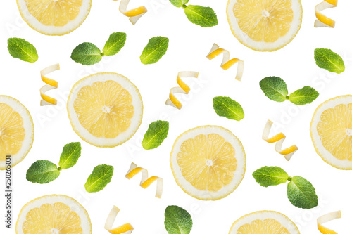 Seamless pattern of Round slices of lemon, shavings of lemon zest and mint leaves on a white background. Isolate.