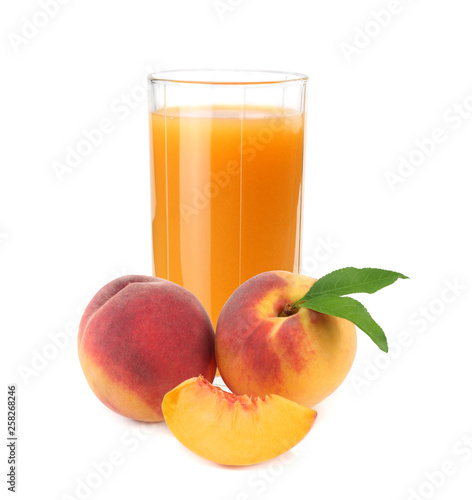 glass of peach juice with peach fruit and slices isolated on white background.