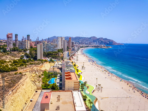 Poniente beach of Benidorm in summer seen from the heights of a skyscraper with the beach, the sea and other buildings of hotels and apartments. photo