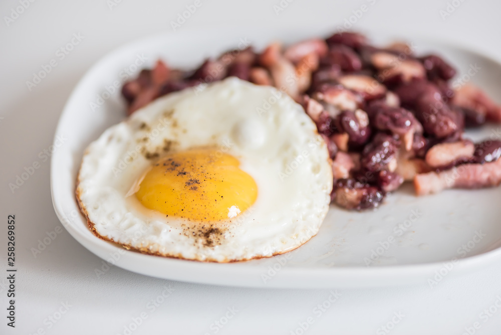 English tastefull breakfast with fried bacon, beans and eggs English tastefull breakfast with fried bacon, beans and eggs